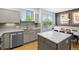 Well-lit kitchen with a modern sink, stainless steel appliances, and countertop space at 84 Spruce St # 707, Denver, CO 80230