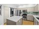 Stylish kitchen featuring stainless steel appliances, an island, and sleek countertops at 84 Spruce St # 707, Denver, CO 80230