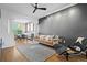 Open-concept living room boasts hardwood floors, dark accent wall, decorative rug, and an inviting seating area at 84 Spruce St # 707, Denver, CO 80230