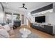 Bright living room with a fireplace, modern furniture, and access to a staircase at 84 Spruce St # 707, Denver, CO 80230