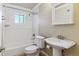 Bright bathroom features a shower-tub combination and a pedestal sink with a medicine cabinet at 1330 Elizabeth St # 8, Denver, CO 80206
