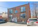 Apartment building has brick facade, balconies, and ample parking in a central location at 1330 Elizabeth St # 8, Denver, CO 80206