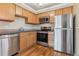 Kitchen with stainless steel appliances, granite countertops, and wood cabinets at 1330 Elizabeth St # 8, Denver, CO 80206
