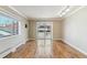 Bright open living room featuring large windows, hardwood floors, and access to a balcony at 1330 Elizabeth St # 8, Denver, CO 80206