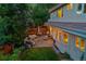 Aerial view of a backyard featuring an outdoor seating area with a fire pit and string lights at 2558 Premier Pl, Boulder, CO 80304