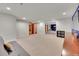 Finished basement with french doors, neutral carpet, and an open doorway to another room with built-in shelving at 2558 Premier Pl, Boulder, CO 80304