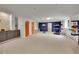 Spacious finished basement featuring exercise equipment, storage, sink, and a contrasting navy blue accent wall at 2558 Premier Pl, Boulder, CO 80304