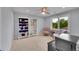 Cozy bedroom featuring a ceiling fan, built-in bookshelves, neutral walls, and natural light from a window at 2558 Premier Pl, Boulder, CO 80304