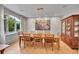 Inviting dining room featuring a modern chandelier, a large window, and stylish decor with wooden table and chairs at 2558 Premier Pl, Boulder, CO 80304