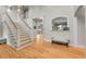 Inviting foyer featuring hardwood floors, a staircase, and an arched window with custom millwork at 2558 Premier Pl, Boulder, CO 80304