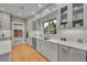 Bright white kitchen with stainless steel appliances, herringbone backsplash, quartz countertops and plenty of storage space at 2558 Premier Pl, Boulder, CO 80304