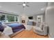 Main bedroom with fireplace, hardwood floors, a ceiling fan, and lots of natural light at 2558 Premier Pl, Boulder, CO 80304