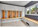 Mudroom with built-in storage lockers, drawers, and a bench, complemented by stylish wallpaper and herringbone floors at 2558 Premier Pl, Boulder, CO 80304