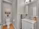 Updated powder room with a marble vanity, chrome fixtures, and a stylish mirror at 2558 Premier Pl, Boulder, CO 80304