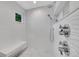 Shower room features a bench, sleek fixtures, and textured white tile walls at 2558 Premier Pl, Boulder, CO 80304