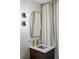 Bathroom featuring a vanity with a sleek sink, modern lighting, and a tiled wall at 199 S Ivy St, Denver, CO 80224