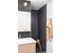 Stylish bathroom featuring a modern sink, dark tiled shower, and wooden stool, creating a spa-like atmosphere at 199 S Ivy St, Denver, CO 80224