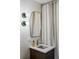 Bathroom features modern vanity, square tiling, and a unique mirror shape at 199 S Ivy St, Denver, CO 80224