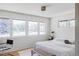 Bright bedroom featuring large windows with natural light and a chair, creating a cozy and minimalist retreat at 199 S Ivy St, Denver, CO 80224