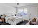 Bright bedroom with white walls, neutral decor, and a view of the outside patio at 199 S Ivy St, Denver, CO 80224