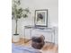 Stylish bedroom featuring a glass-top desk with a round ottoman and potted tree, creating a serene atmosphere at 199 S Ivy St, Denver, CO 80224