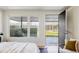 Bedroom view to patio through large windows and sliding black door, neutral decor at 199 S Ivy St, Denver, CO 80224