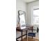 Desk nook with a black framed mirror, next to a window and modern chair at 199 S Ivy St, Denver, CO 80224