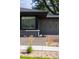 Close-up view of modern home featuring gray brick and complementing dark window frames at 199 S Ivy St, Denver, CO 80224