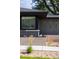 Close up of the exterior showing gray brick and well-maintained landscaping at 199 S Ivy St, Denver, CO 80224