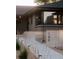 Contemporary gray brick home with decorative brick wall and modern rain chain at 199 S Ivy St, Denver, CO 80224