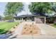 Well-maintained home with modern xeriscaping and a brick facade near the driveway at 199 S Ivy St, Denver, CO 80224