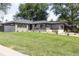 Charming single-story home with well-manicured lawn and mature trees at 199 S Ivy St, Denver, CO 80224