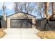 Detached garage with a modern overhead door and a wide concrete driveway at 199 S Ivy St, Denver, CO 80224