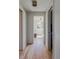 Hallway with hardwood floors leading to a room with large windows for natural light at 199 S Ivy St, Denver, CO 80224