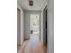 Hallway with hardwood floors and view into a bedroom with bright natural light at 199 S Ivy St, Denver, CO 80224