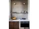 Modern kitchenette with stainless steel oven and decorative tile backsplash at 199 S Ivy St, Denver, CO 80224