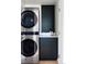 Clean laundry room featuring stainless steel stackable washer and dryer at 199 S Ivy St, Denver, CO 80224