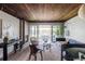 Bright living room featuring a fireplace, wood-paneled ceiling, and sliding doors to the outdoor patio at 199 S Ivy St, Denver, CO 80224