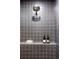 Modern shower with gray tile, overhead shower head, and built-in shelf with minimalist decor for a relaxing experience at 199 S Ivy St, Denver, CO 80224