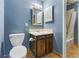 Clean bathroom with dark vanity, tiled floor, and shower/tub combo at 7335 E Quincy Ave # 303, Denver, CO 80237