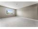 Bright bedroom with grey carpet and large window with blinds at 7335 E Quincy Ave # 303, Denver, CO 80237