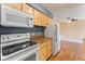 Kitchen boasts white appliances and wood cabinets at 7335 E Quincy Ave # 303, Denver, CO 80237