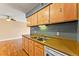 Bright kitchen features wood cabinets, double sink, and built-in dishwasher at 7335 E Quincy Ave # 303, Denver, CO 80237