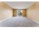 Living Room with sliding door to balcony and neutral colored carpet at 7335 E Quincy Ave # 303, Denver, CO 80237