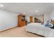Basement bedroom with carpeted floors and a large TV cabinet for entertainment and convenient bedroom storage at 12906 Cherry Way, Thornton, CO 80241