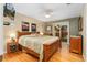 Primary bedroom boasts a king bed, hardwood floors, ceiling fan, and access to the backyard at 12906 Cherry Way, Thornton, CO 80241