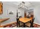 Dining room featuring modern light fixture and connection to multiple rooms at 12906 Cherry Way, Thornton, CO 80241