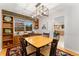 Well-lit dining room with stylish lighting and built in shelving at 12906 Cherry Way, Thornton, CO 80241