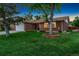 Charming red brick home with a well-manicured lawn, mature trees, and an attached two car garage at 12906 Cherry Way, Thornton, CO 80241