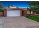 Exterior of the house with two car garage and concrete driveway and lawn at 12906 Cherry Way, Thornton, CO 80241